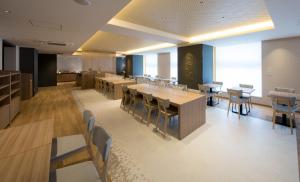 a restaurant with wooden tables and chairs and a cafeteria at Shizutetsu Hotel Prezio Kyoto Shijo in Kyoto