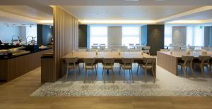 a dining room with a large table and chairs at Shizutetsu Hotel Prezio Kyoto Shijo in Kyoto
