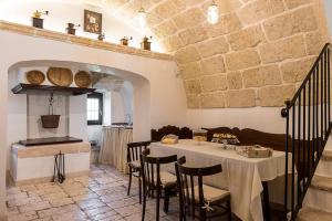 a dining room with a table and some chairs at Masseria Santo Stefano Relais&Charming House in Conversano