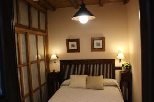 a bedroom with a bed with two pillows on it at Cau La Mar in Lastres