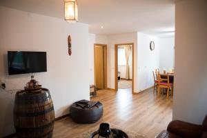 a living room with a tv on the wall and a table at CASA DA CASADA VILLA RURAL - FOZ DO DOURO by LW in Foz do Sousa