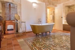a large bathroom with a tub in a room at Masseria Santo Stefano Relais&Charming House in Conversano +89 photos