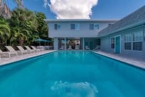 a swimming pool in front of a house at Mulberry Cottage in Siesta Key