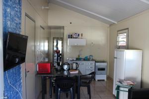 uma pequena cozinha com uma mesa e um frigorífico em Casa mobiliada em Três Lagoas