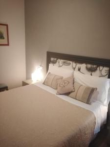 a bedroom with a large bed with white pillows at Casa Francesca in Ravenna