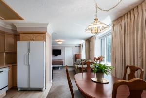 a kitchen with a table and a white refrigerator at The Kimball at Temple Square in Salt Lake City