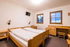 Postel nebo postele na pokoji v ubytování Horský Hotel Kohútka