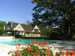 a house with a swimming pool in front of a house at Les Vieux Guays in Cerdon