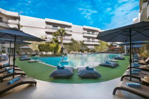 a pool at a hotel with chairs and umbrellas at Kech Boutique Hotel & Spa in Marrakesh