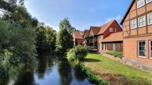 a river in a town with houses next to a canal at Auenglück (inkl. THERMEplus) in Bad Bevensen