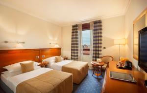 Postel nebo postele na pokoji v ubytování Best Western Premier Hotel Astoria + 37 fotografií