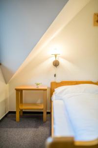 Postel nebo postele na pokoji v ubytování Horský Hotel Kohútka