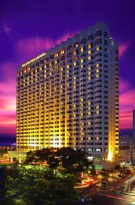 
a large building with a large clock on it at Diamond Hotel Philippines - Multiple Use Hotel in Manila
