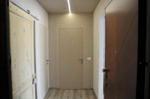 an empty hallway with a door and a hallway at Civico51 in San Damiano dʼAsti +8 photos