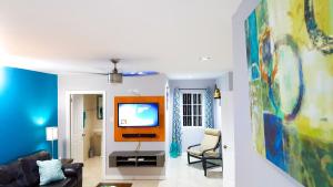 a living room with a couch and a tv at Donhead New Kingston Apt 3 in Kingston