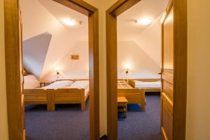 Postel nebo postele na pokoji v ubytování Horský Hotel Kohútka