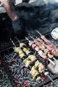 a bunch of food being cooked on a grill at Duende Hotel in Lagodekhi