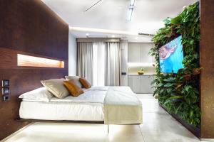 a bedroom with a bed with a plant wall at Costa Rica Bibione SPA in Bibione