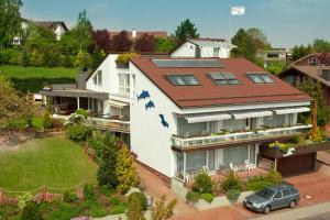 a house with a roof with a car parked in front at Haus Delphin in Bad Wildungen