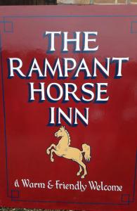 a sign for the rambunctious horse inn at The Rampant Horse Public House in Fakenham
