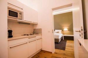 A kitchen or kitchenette at Helvetia Suites