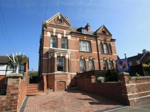 a large brick house with a brick driveway at Falcon House By RentMyHouse in Hereford
