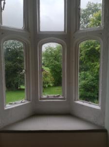 a window that is open in the middle of a garden at Greenham Hall in Wellington