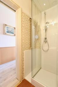 a shower with a glass door in a bathroom at Hotel Victoria in Lugano