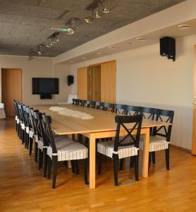 a conference room with a large wooden table and chairs at Saulepa Seaside Villa in Saulepa