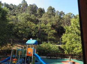 a view of a water park with a playground at Casa Rural El Tejo in Arroyo Frio