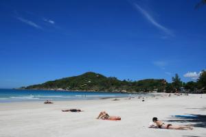a group of people laying on a beach at Palita Lodge - SHA Plus in Haad Rin