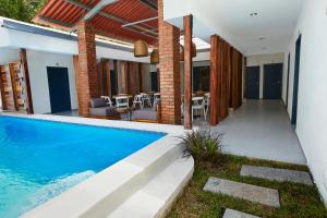 a house with a swimming pool and a patio at Villavela Hotel Boutique in Sonsonate