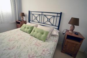 a bedroom with a bed and a lamp on a table at Casa Lola in Agaete