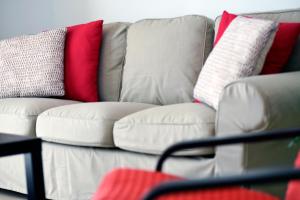 a white couch with different colored pillows on it at Casa Lola in Agaete