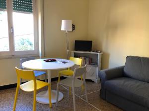 a living room with a table and chairs and a couch at LIGURIA HOLIDAYS - "La Casa di Gisella" in Camogli