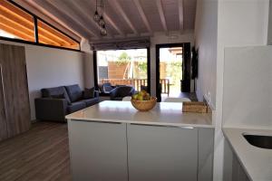 a kitchen with a bowl of fruit on a counter at Apartamentos La Playina in Llanes