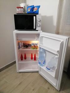 a small white refrigerator with its door open at Marconi 11 in Bardello