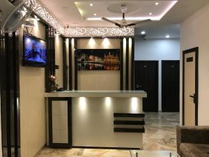 a bar in a hotel lobby with a tv at Hotel Kabir Residency-4 MIN WALK TO GOLDEN TEMPLE in Amritsar