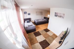 a living room with a room with a bed and a couch at Appartement/Ferienwohnung in Grafling