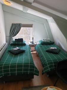 Tempat tidur dalam kamar di Pension Groeneweg