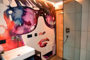 a bathroom with a painting of a horse on the wall at Ferienhaus Rauter in Oberndorf in Tirol +20 photos