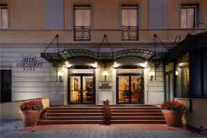 a building with stairs and flowers in front of it at Hotel President in Viareggio