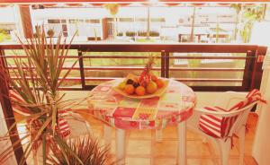 a table with a bowl of fruit on a balcony at Studio in perfect location in Playa de las Americas