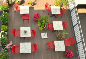 an overhead view of a table and chairs and flowers at Lizz Hotel Munich in Munich