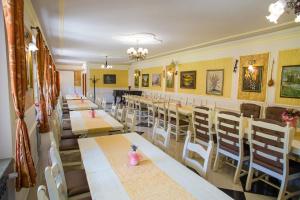 a row of tables and chairs in a restaurant at Garden in Varaždinske Toplice