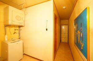 a laundry room with a washer and dryer and a hallway at Private House IT / Vacation STAY 47911 in Takayama