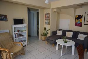 a living room with a couch and a table at Christinas garden in Patra