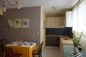 a kitchen with a table with a yellow table cloth at Christinas garden in Patra
