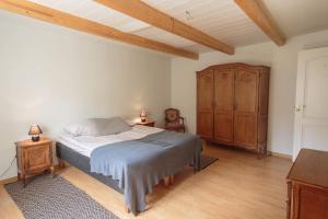een slaapkamer met een bed en een houten kast bij 3 bedroom unique apartment in Old Town in Tallinn