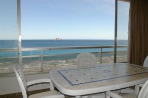 a table and chairs with a view of the ocean at Apartamentos Carolina - Arca Rent in Benidorm